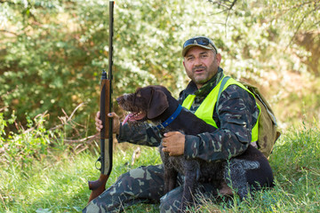 Hunter with a German trotter and spaniel, hunting a pheasant with dogs	