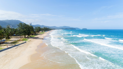 Naklejka premium Beautiful wave crashing on sandy shore at karon beach in phuket thailand,aerial view drone shot.