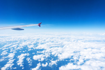 Plane wing on the blue sky and clouds,can be used for air transport to travel and open season to travel background