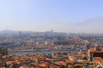 Naklejka premium Scenic view of Porto, Portugal from the tower Clérigos Church. River Douro. Orange roofs of the houses.