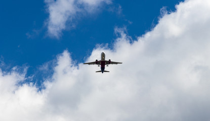 background. defocus. airplane in blue sky with gray and white clouds