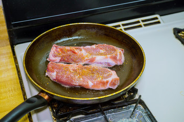 Pork chop with clary in frying pan grill closeup