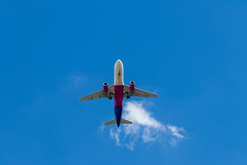background. defocus. airplane in blue sky with gray and white clouds