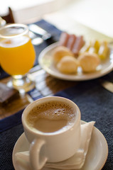 cup of coffee and cake on table
