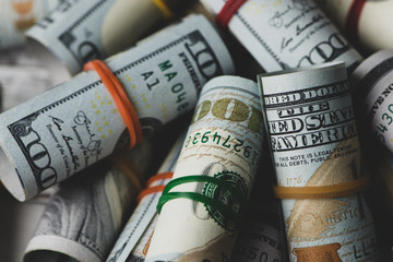 US dollars in roll on money background