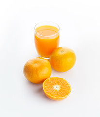 A glass of orange juice and an oranges isolated on white background 