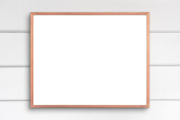 Obraz premium Old picture frame on white wood wall.