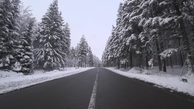 Driving in a winter landscape in a forest
