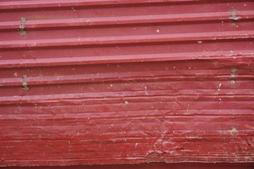 Dented red corrugated metal horizontal background