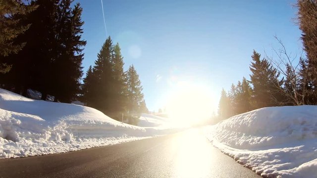Driving in winter landscape with the blinding sun 