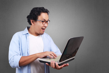 Young Man Playing with His Laptop