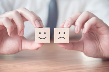 Businessman showing rating with happy and sad icon, Customer satisfaction survey concept