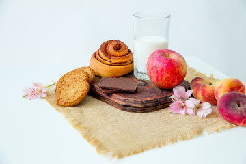 Homemade cinnamon buns in glaze on a dark plate with berries