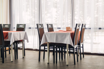 Dining tables and chairs in the restaurant. Light interior