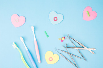 Dental tools use for dentist on the blue background, flat lay, top view.