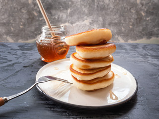 Light breakfast. Homemade freshly baked punkcake slide on a plate with syrup.
