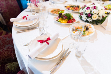 Wedding decorated table. Luxury light decor on table in restaurant	