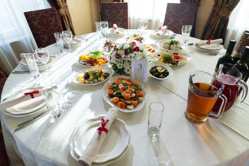 Wedding decorated table. Luxury light decor on table in restaurant	