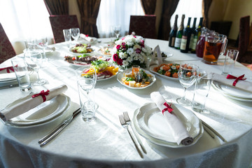 Wedding decorated table. Luxury light decor on table in restaurant	