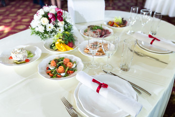 Wedding decorated table. Luxury light decor on table in restaurant	