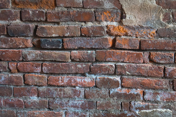 Broken brick walls with little plaster left