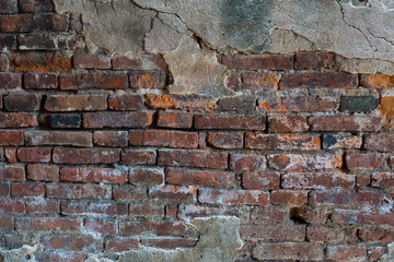 ruined brick wall with cracking plaster cement
