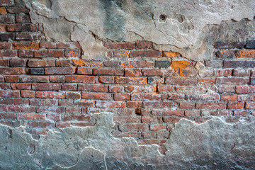 whole ruined and broken bricks wall with cracking cement
