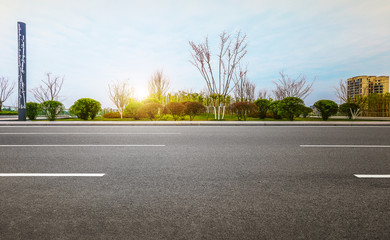 Modern city park and clean asphalt highway