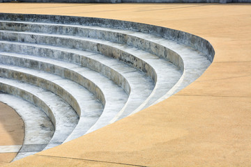 abstract concrete stairs architecture details in semicircle shape with yellow color pebble washed floor