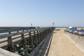 Obraz premium Green and red lighthouses on the coast of Trouville
