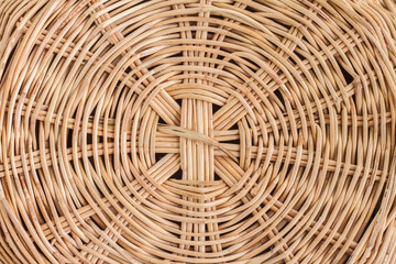 Closeup bottom of  brown rattan basket.