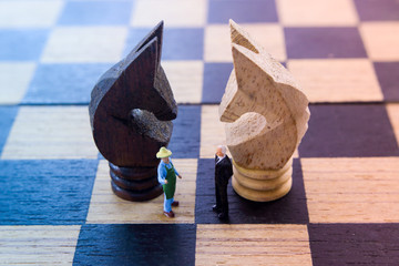 Businessman.confront.Farmers on the chess board