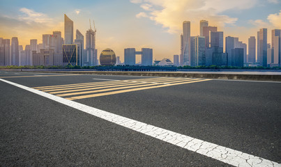 Fototapeta premium Urban road asphalt pavement and skyline of Hangzhou architectural landscape