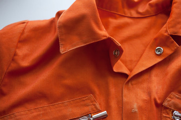 An orange jumpsuit of a prisoner. Serving of compulsory execution of court decisions