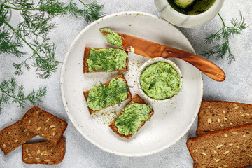 Delicious appetizer - butter with dill greens on rye bread with sunflower seeds