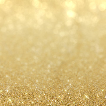 Beautiful gold background with sparkling glitter and bokeh light