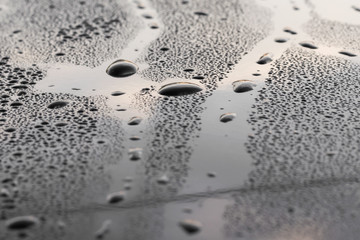 drops of water on a black surface