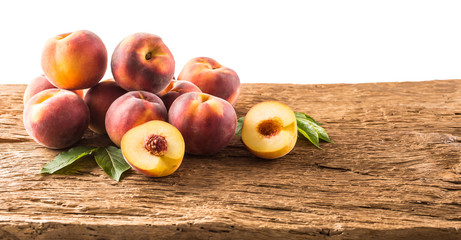 Freshly ripe peaches on the old wooden table.