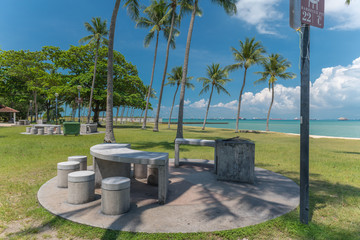 Barbecue area in east Coast Park with table and stools, Singapore.