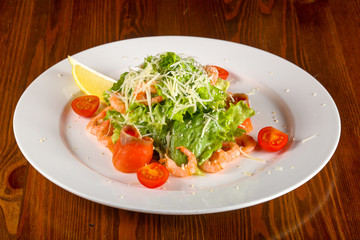 Caesar salad with shrimps and salmon