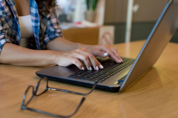 Woman using her laptop in a cafe