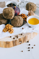 Fototapeta premium Swiss cheese belper knolle on wooden board with figs, nuts and honey