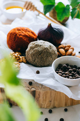 Swiss cheese belper knolle on wooden board with figs, nuts and honey