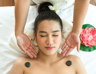 Beautiful woman lying in spa salon and enjoying face massage, Health care concept.
