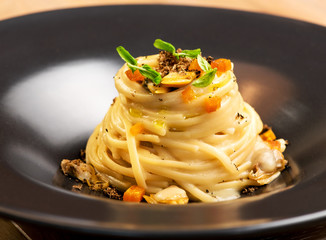 Gourmet appetizer with linguine, clams and truffle