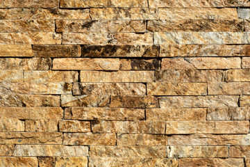 Stone wall of natural stones in different sizes. The facade of the house.