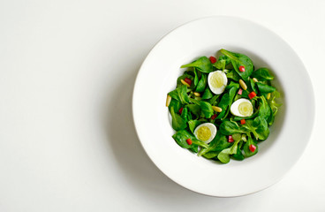 Spring salad, spinach and quail egg