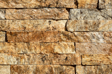 Stone wall of natural stones in different sizes. The facade of the house.