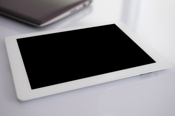 Demo blank screen of tablet on the desk. isolated black screen for insert data, image and etc