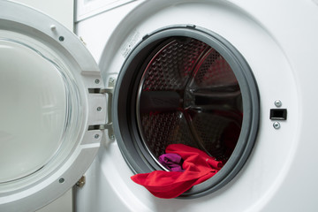 Image of open washing machine with red cloth